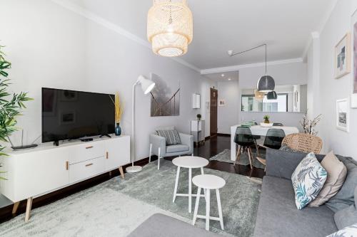 a living room with a couch and a dining room at Santa Catarina II by An Island Apart in Funchal