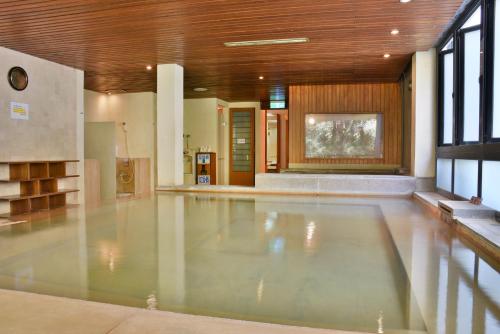 an empty swimming pool in a building with a lobby at Honey Moon Hotel in Renai
