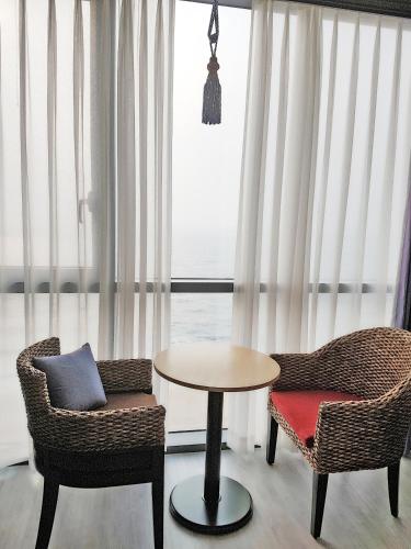 a table and chairs in a room with a window at Hotel Wooyeon Flora in Boryeong