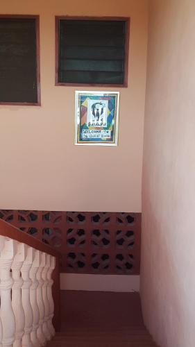 a room with a wall with wine racks and a window at IS Guest House in Cape Coast