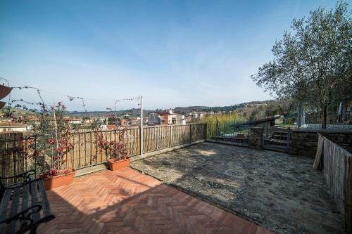 a balcony with a bench and a view of a city at Rocca Palazzaccio in Impruneta