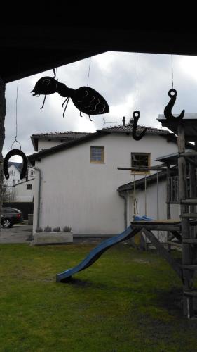 a crab decorations hanging from a house with a playground at Penzion Olga in Mariánské Lázně