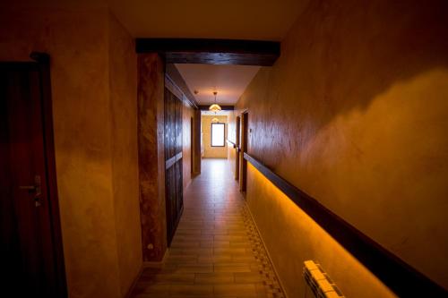 a hallway with a long corridor with a light at the end at Willa STRITZKI in Wisła