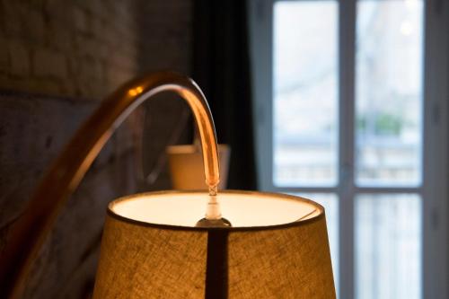 a close up of a candle in front of a window at La Canonica - charming self-catering apartments in Nizza Monferrato in Nizza Monferrato