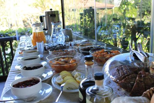 a table topped with dishes of food and bottles of wine at Efe Hotel Gocek in Göcek