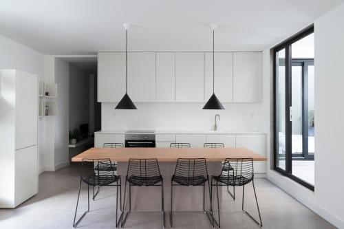 a kitchen with a wooden table and chairs at Lisbon Domus 74 by amcf in Lisbon