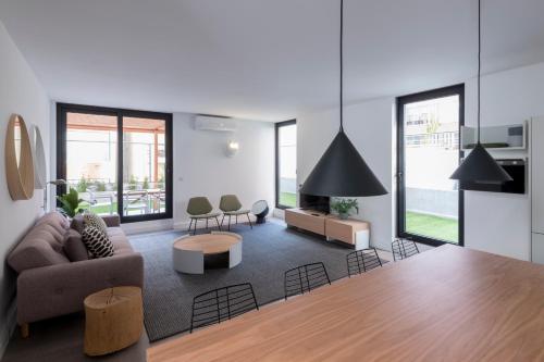 a living room with a couch and a table at Lisbon Domus 74 by amcf in Lisbon