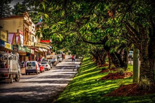 a street with cars parked on the side of the road at Mountain Whispers Varenna Luxury in Leura