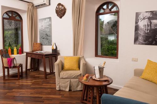 a living room with a couch and a table at Essque Zalu Zanzibar in Nungwi