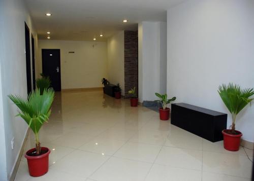 a hallway with potted plants in a building at Hotel Sri Krishna Residency in Udupi