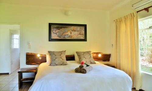 a bedroom with a bed with teddy bears on it at Elephant Walk Retreat in Komatipoort