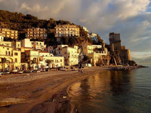 a group of white houses on a hill next to the water at Zifina in Cetara
