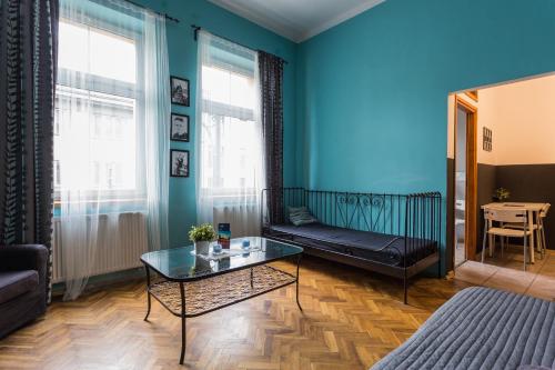 a living room with a couch and a table at Nobel Suites in Kraków