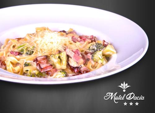 a plate of pasta with broccoli and cheese at Motel Dacia in Sebeş
