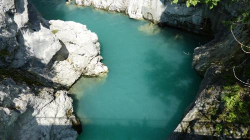 an aerial view of a body of water between rocks at Pension Hirsch in Lechbruck