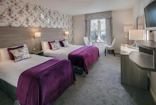 a hotel room with two beds and a bathroom at The Landmark Hotel in Carrick on Shannon