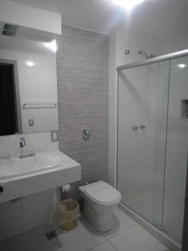 a bathroom with a shower and a toilet and a sink at Hotel Premier (Adult Only) in Nilópolis