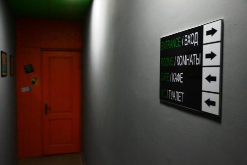 a sign on a wall next to a door at Daeli Hotel in Mestia