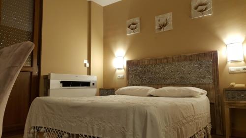 a hotel room with a bed and a television at Los Acebos Cangas in Cangas de Onís