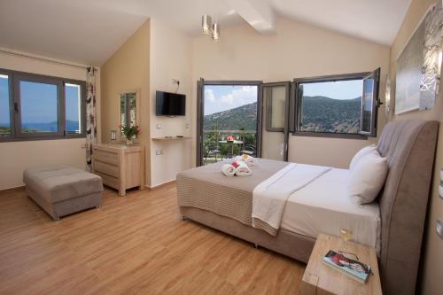 a bedroom with a bed and a large window at Kefalonia Horizon Villas in Agia Effimia