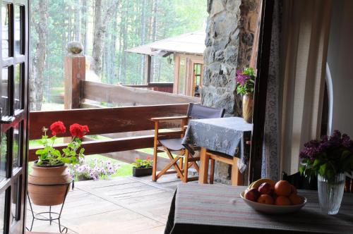 a porch with a table and chairs on a balcony at Apartments Carevo Polje in Zlatibor