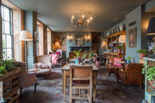 a living room filled with furniture and decor at THE PIG-in the wall in Southampton
