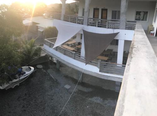 a balcony of a building with a boat in front of it at Seabreeze Beach Lodge in Nasugbu