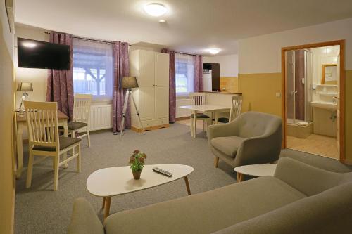 a living room with a couch and chairs and a table at Landhotel & Brauhaus Prignitzer Hof in Pritzwalk