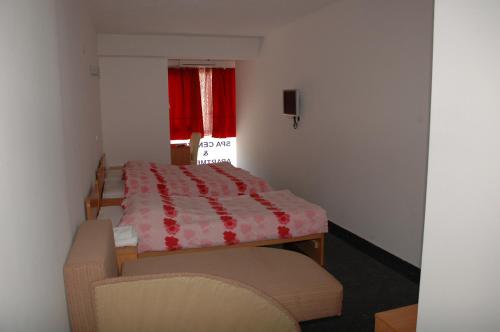 a bedroom with a bed and a chair and a window at Villa Sparadise in Ohrid