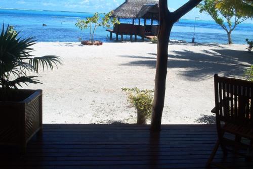a view of the beach from the porch of a resort at Pension Motu Iti in Pihaena