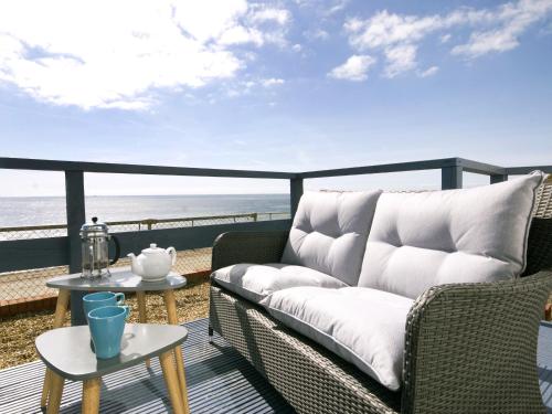 a living room with a couch and a view of the beach at Sail Away Holiday Villa in Ventnor
