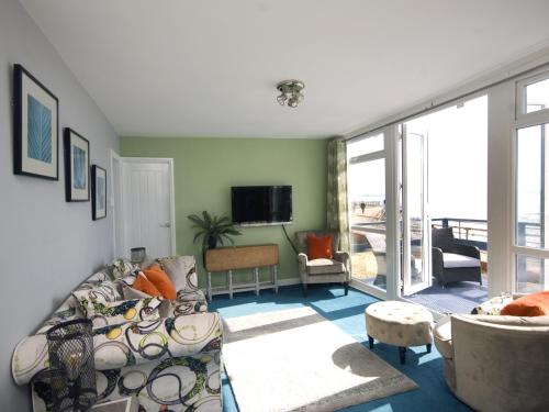 a living room with a couch and a tv at Sail Away Holiday Villa in Ventnor