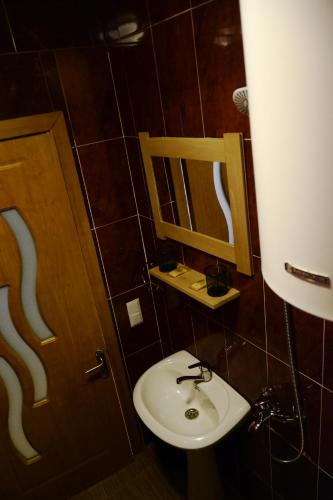 a bathroom with a sink and a mirror at Daeli Hotel in Mestia