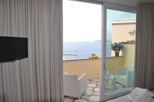 a room with a balcony with a view of the ocean at Terra Murata Boutique b&b in Procida