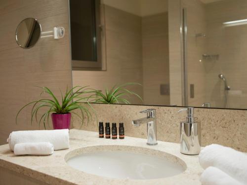 a bathroom with a sink and a mirror at Crvena Luka Resort in Biograd na Moru