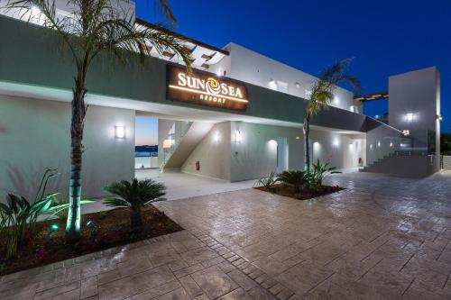 a building with a sign that reads singapore sea hotel at Sun and Sea Plus Resort in Plaka