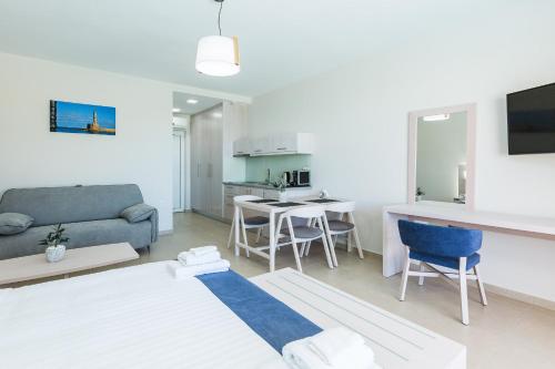 a living room with a couch and a table at Sun and Sea Plus Resort in Plaka
