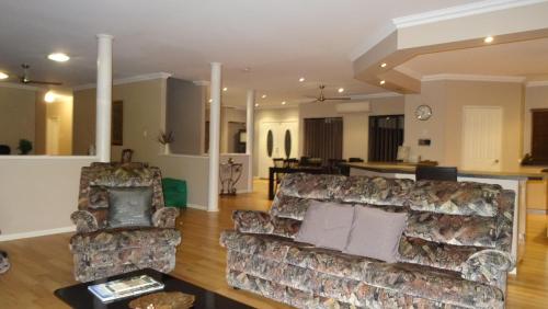 a living room with two couches and a table at Mountain Park Retreat in Perth