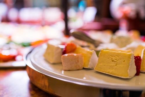 a plate of different types of cheeses on a table at Strandhotel Ostfriesenhof in Borkum