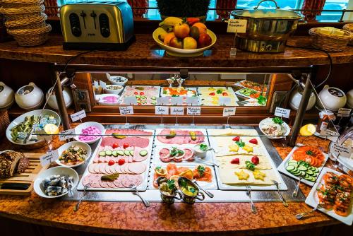 a buffet with many different types of food on display at Strandhotel Ostfriesenhof in Borkum
