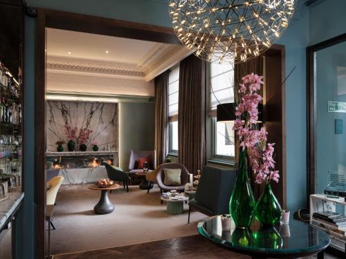 a living room filled with furniture and flowers at Signature Townhouse London Hyde Park in London