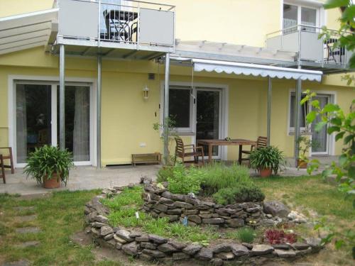 a house with a patio with a rock garden at Haus Gartentraum in Sommerhausen