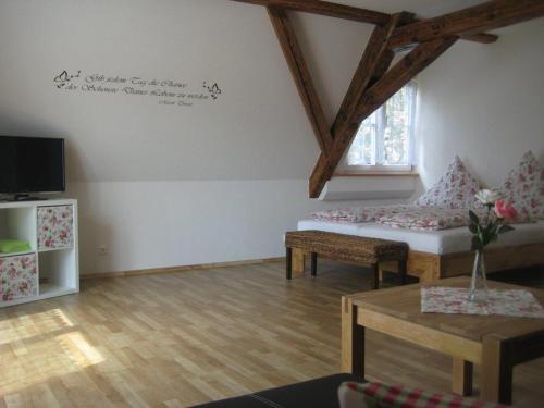 a living room with a couch and a table at Haus Gartentraum in Sommerhausen