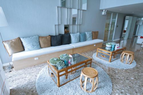 a living room with a couch and two tables at Baan Imm Aim Condo Hua Hin in Hua Hin