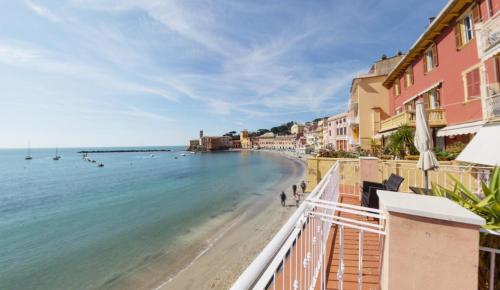a view of a beach with buildings and the ocean at Hotel Miramare & Spa in Sestri Levante