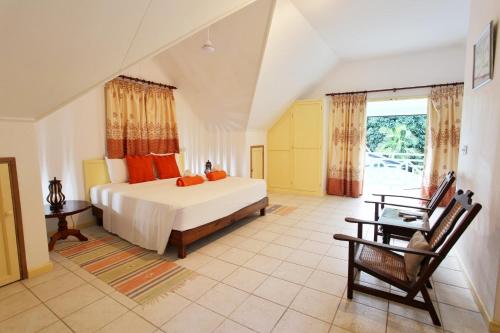 1 dormitorio con cama y ventana grande en Villa Kordia, en Pointe Au Sel 