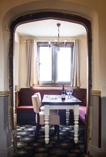 a dining room with a table and a window at The Boars Head Hotel in Sudbury