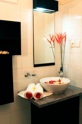 a bowl on a counter in a bathroom at Taman Ayu Town House in Denpasar