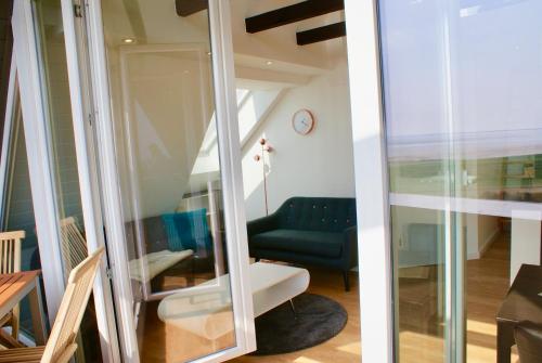 a room with a couch and a chair at Deichhotel Rose in Juist