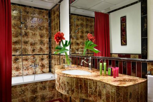 a bathroom with a sink and a red curtain at Hotel Berchielli in Florence